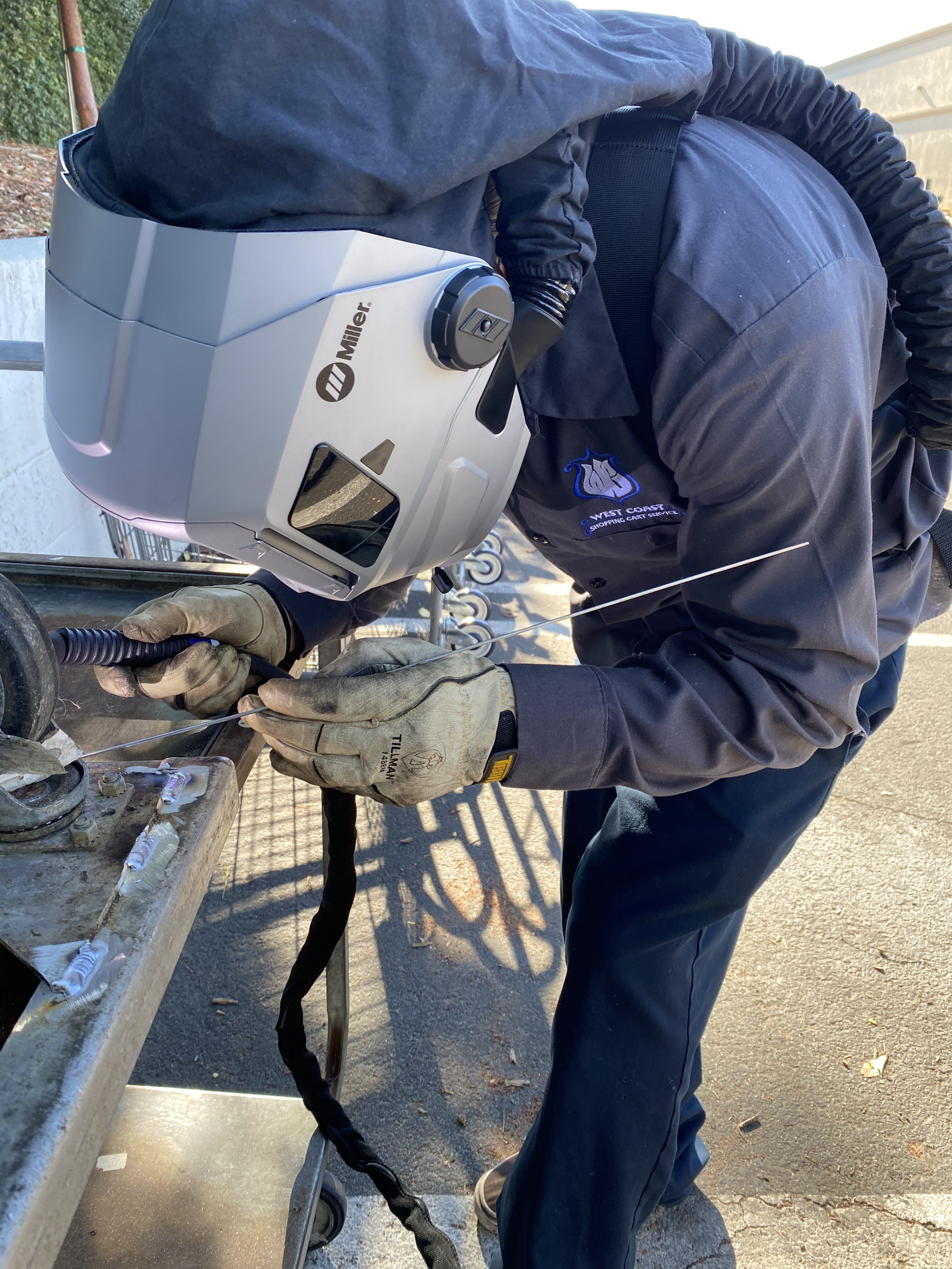 West Coast Shopping Cart Service technician welding a shopping cart